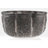 A Chinese silver repousse sugar bowl, c1900, the lobed sides crisply chased with panels of