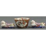 A pair of Chinese miniature figures of boys and a Batavian Ware tea bowl, Qing dynasty and