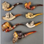 Three Meerschaum tobacco pipes, c1900, the bowl carved as the head of an elegant woman or bearded