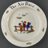 A Bishop and Stonier earthenware baby's plate, c1920, printed and painted with The Air Race, 20cm