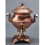 A Victorian copper tea urn and cover with brass tap, 37cm h Typical wear, glass handles intact