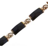 A South East Asian gold and black onyx bracelet, with pierced and engraved dragon panels, marked