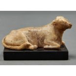 A miniature marble sculpture of a recumbent cow, 19th c, on rectangular slate base, 10.5cm l Wear