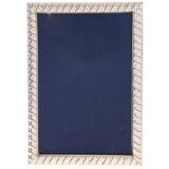 A silver photograph frame, early 21st c, with fluted mount backed on wood, 17 x 12cm, marked 925