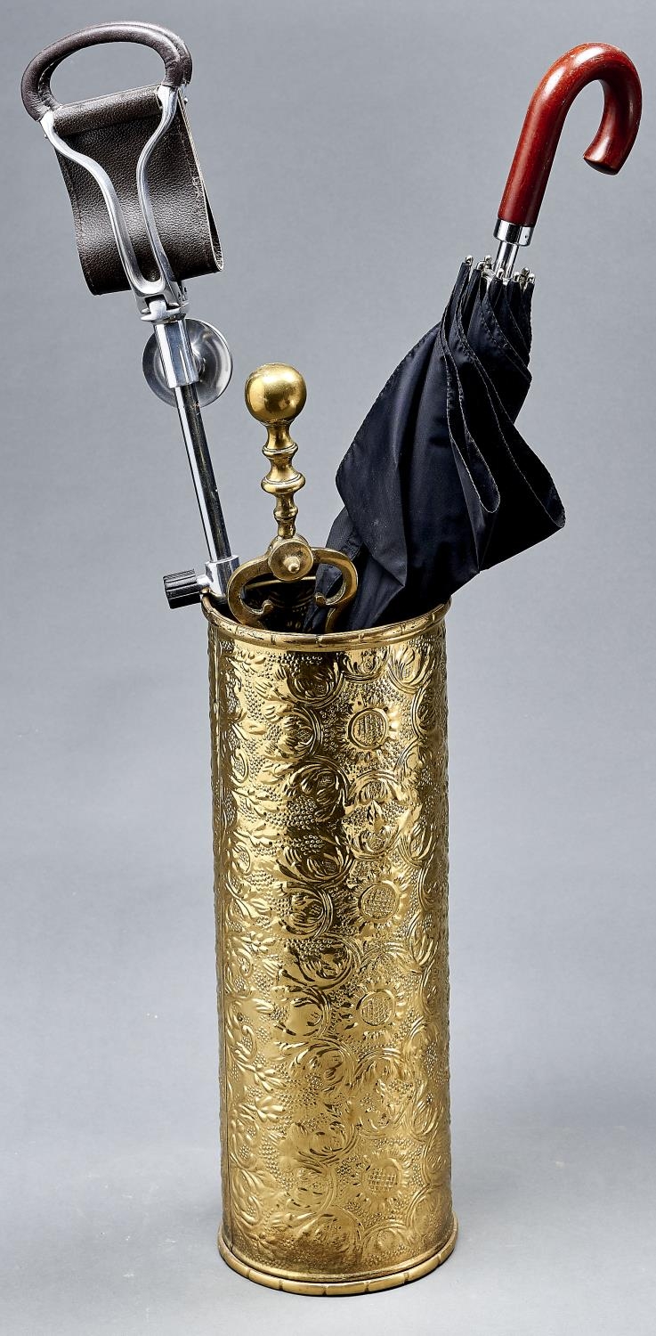 An embossed brass stick stand, shooting stick, umbrella and pair of brass coal tongs