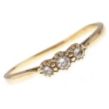 A three stone diamond ring, in 18ct gold, 2.7g, size T Hoop worn and slightly distorted
