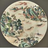 A Chinese famille verte dish, Qing dynasty, Kangxi mark, 19th c, painted with a river scene,