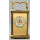A French brass carriage timepiece, with primrose enamel chapter ring and giltmetal mask, key, 11cm h