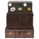 A rectangular wooden bound fabric covered trunk, applied lacquered brass clasps, lock plates with