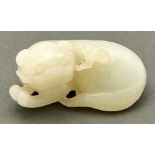 A Chinese celadon jade pebble carving of a dog and linghzi, 19th / 20th c, 50mm l Undamaged