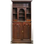 An oak double cabinet, the flared cornice above shelf, arched portico short shelves and small
