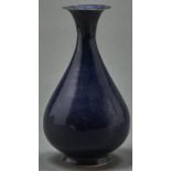 A Chinese blue monochrome glazed vase, with flared neck and foot, 27.5cm h Rim chipped