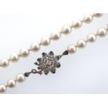 A cultured pearl necklace with sapphire and diamond set white gold clasp, marked 750, 55.9g Good