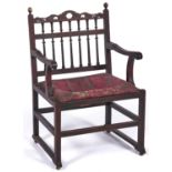 A George III mahogany chair, late 18th c, with over scrolled arms and sledge stretchers, seat height