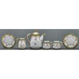 A Noritake tea service for two, c1930, decorated with roses and swags, teapot and cover 13cm h,