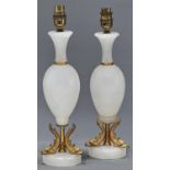 A pair of giltmetal mounted white onyx baluster table lamps, with waisted necks, ovoid bodies