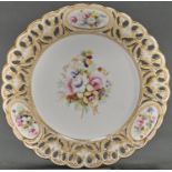 An English porcelain dessert plate, c1870, painted with a central floral group with prominent roses,