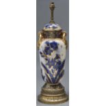 A brass mounted Royal Doulton type blue and gilt earthenware vase and cover table lamp, c1910,