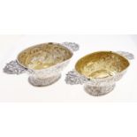 Two similar Dutch silver brandy bowls, with cast mask handles, the bowl and domed foot chased with