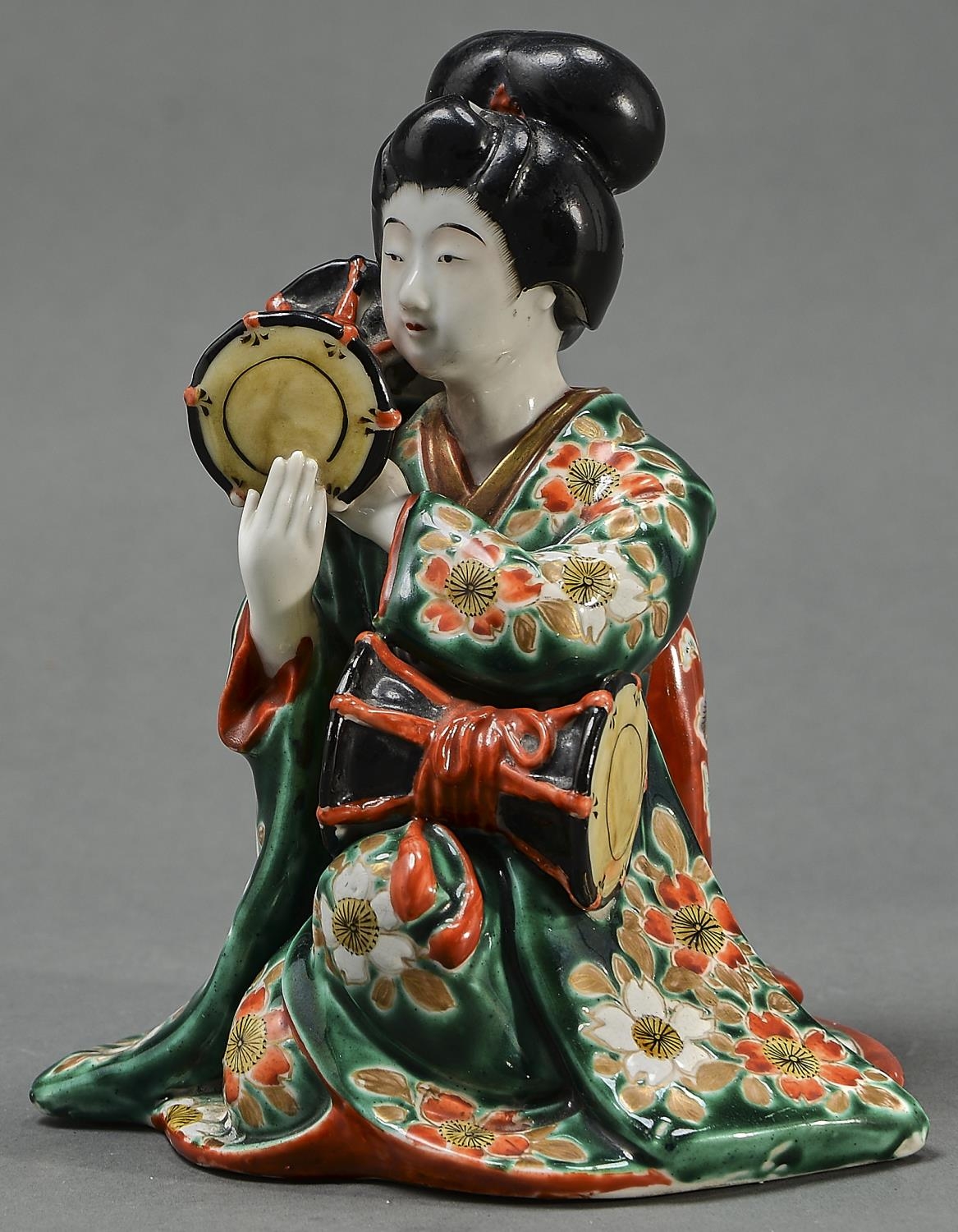 A Japanese Imari figure of a bijin with drums, 20th c, flat unglazed base, 19cm h Generally good