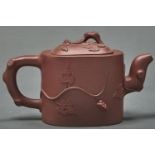 A Chinese Yixing stoneware teapot and cover, of oblong form and applied with squirrel and fruit,