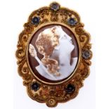 A cameo brooch, 19th c, the oval shell carved with the head of a bacchante, in silver and filigree