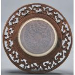 A Chinese intricately carved wood roundel, 19th c  in carved and pierced frame, 12cm diam Good