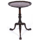 A mahogany tripod table in George III style, mid 20th c, the pie crust top foliate carved to the