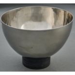 Vera Wang for Wedgwood. A polished stainless steel bowl on black painted wood foot, early 21st c,