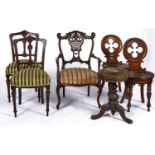 A Victorian walnut revolving piano stool, the circular top above a carved baluster column, three