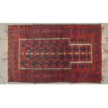 A Caucasian multi coloured border prayer rug, the geometric prayer arch filled with indigo and brown