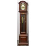 A reproduction mahogany grandmother clock, arched cavetto moulded hood with arched brass dial,