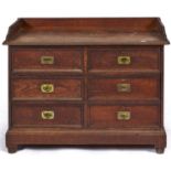 A Victorian oak washstand, c1880, with three quarter gallery above six short panelled drawers with