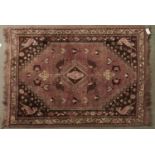 A modern Caucasian multicoloured bordered rug, the pink brown ground worked with central geometric
