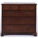 A George III oak chest of drawers, late 18th c, fitted with two short and three graduated moulded