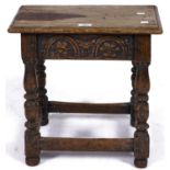 An old reproduction oak joined stool, the rectangular top with moulded lip above arcade carved