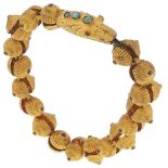 A giltmetal snake bracelet, 19th c, the head set with turquoise, 19.5cm l The articulation still