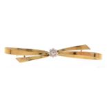 A diamond bow brooch, c1930, illusion set in gold, 50mm, marked 15ct, 3.4g Good condition