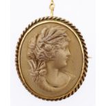 A lava cameo, 19th c, carved in high relief with the head of a woman, mounted in a giltmetal brooch