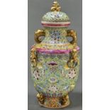 A Chinese lime green ground famille rose vase and cover, with gilt elephant and chilong-and-ring