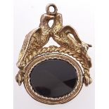 An onyx set 9ct gold swivel fob seal, with billing doves mount, 8.5g Good condition