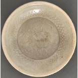A Chinese moulded qingbai 'dragon' dish, Song dynasty, 14.5cm diam Provenance: An English private