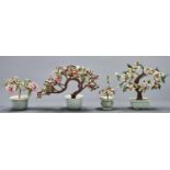 Four Chinese hardstone mounted jewel trees,  the leaves in stained green and pink hardstones with