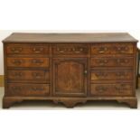 A George III oak dresser, North Wales, late 18th / early 19th c, fitted with drawers and a central