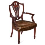 A mahogany and inlaid dining chair, English or Dutch, 19th c, the shield shaped back with carved