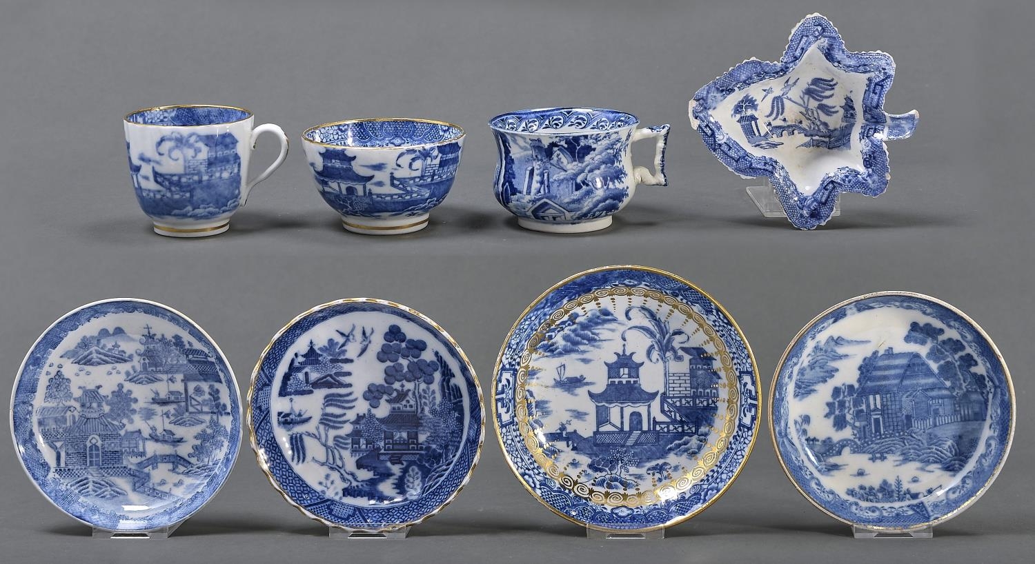 A Coalport fluted blue and white trio, c1800, printed with the Banana Tree pattern, saucer 14cm