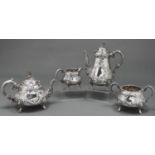 A Victorian silver pear shaped tea and coffee service, chased with flowers and foliage, the domed