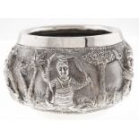 A Burmese silver repousse bowl, c1900, with high relief jataka figures and jungle, 60mm h, maker's