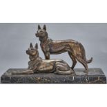 A French bronzed spelter sculpture of two German Shepherd dogs, c1930, on black and gold marble