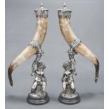 A pair of EPNS mounted horn drinking cups and covers and infant Bacchus silvered metal figural